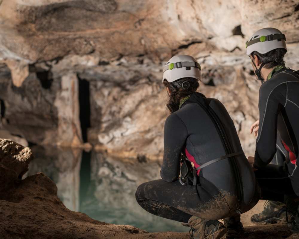 A pair of spelunker exploring a cave, the Grotta di Punta degli Stretti